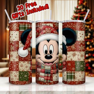 May include: Three stainless steel tumblers featuring Mickey Mouse in a Santa hat and scarf. The tumblers have a red and green patchwork design with snowflakes and floral patterns. Each tumbler includes a straw and the text "20 Free Gifts Included!"