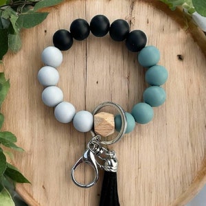 Llavero de pulsera con cuentas neutras y borla