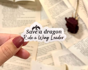 May include: White sticker with a black dragon silhouette and the text "Save a dragon Ride a Wing Leader".