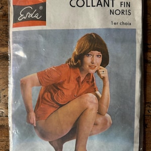 May include: Vintage Erda pantyhose packaging. The image shows a woman in an orange shirt. The packaging has the text "COLLANT FIN NORIS 1er choix". The packaging is clear plastic with a retro design.