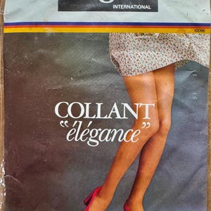May include: A pack of Ergee International tights with the text "COLLANT "élégance"" on the front. The packaging features a woman wearing the tights and pink heels.