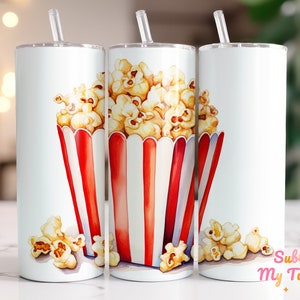 May include: Three white stainless steel tumblers with lids and straws. Each tumbler features a watercolor illustration of a red and white striped popcorn bucket filled with popcorn.