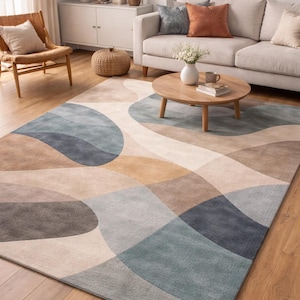 May include: A large area rug with an abstract design in shades of blue, brown, and beige. The rug features a geometric pattern of overlapping shapes, adding a modern touch to the living room setting. The rug is placed on a hardwood floor.