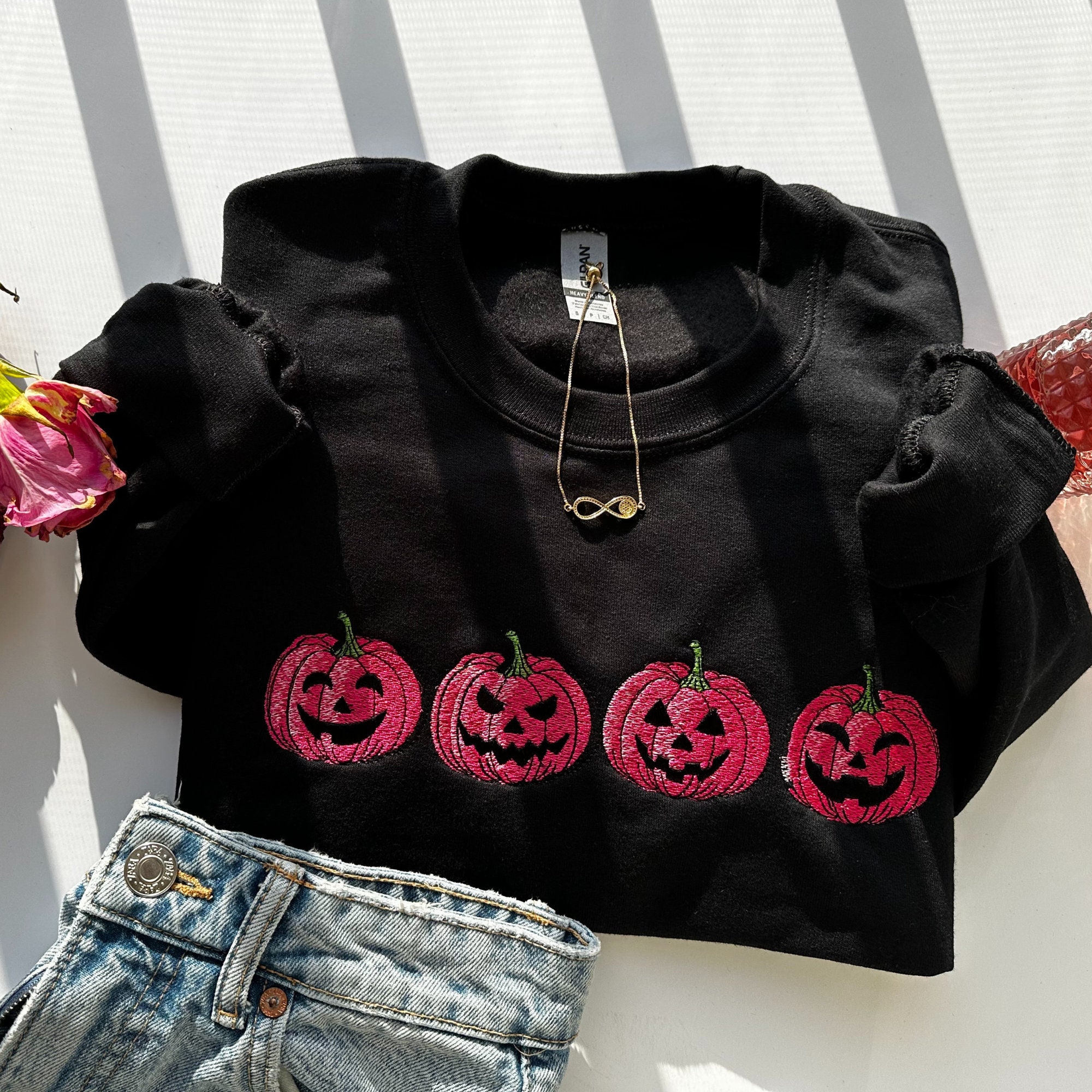 Discover Embroidered Pink Spooky pumpkin Face Crewneck sweatshirt, Halloween Crewneck Sweatshirt, Halloween Sweater, Spooky Season