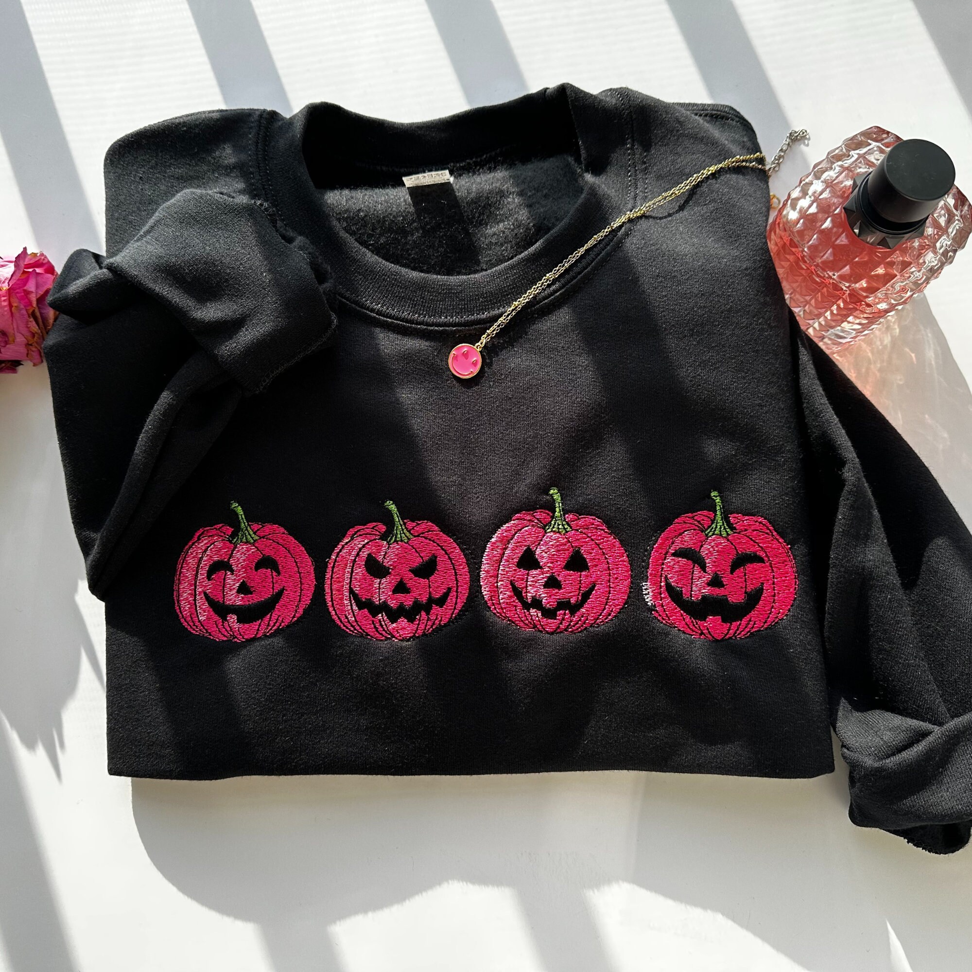 Discover Embroidered Pink Spooky pumpkin Face Crewneck sweatshirt, Halloween Crewneck Sweatshirt, Halloween Sweater, Spooky Season