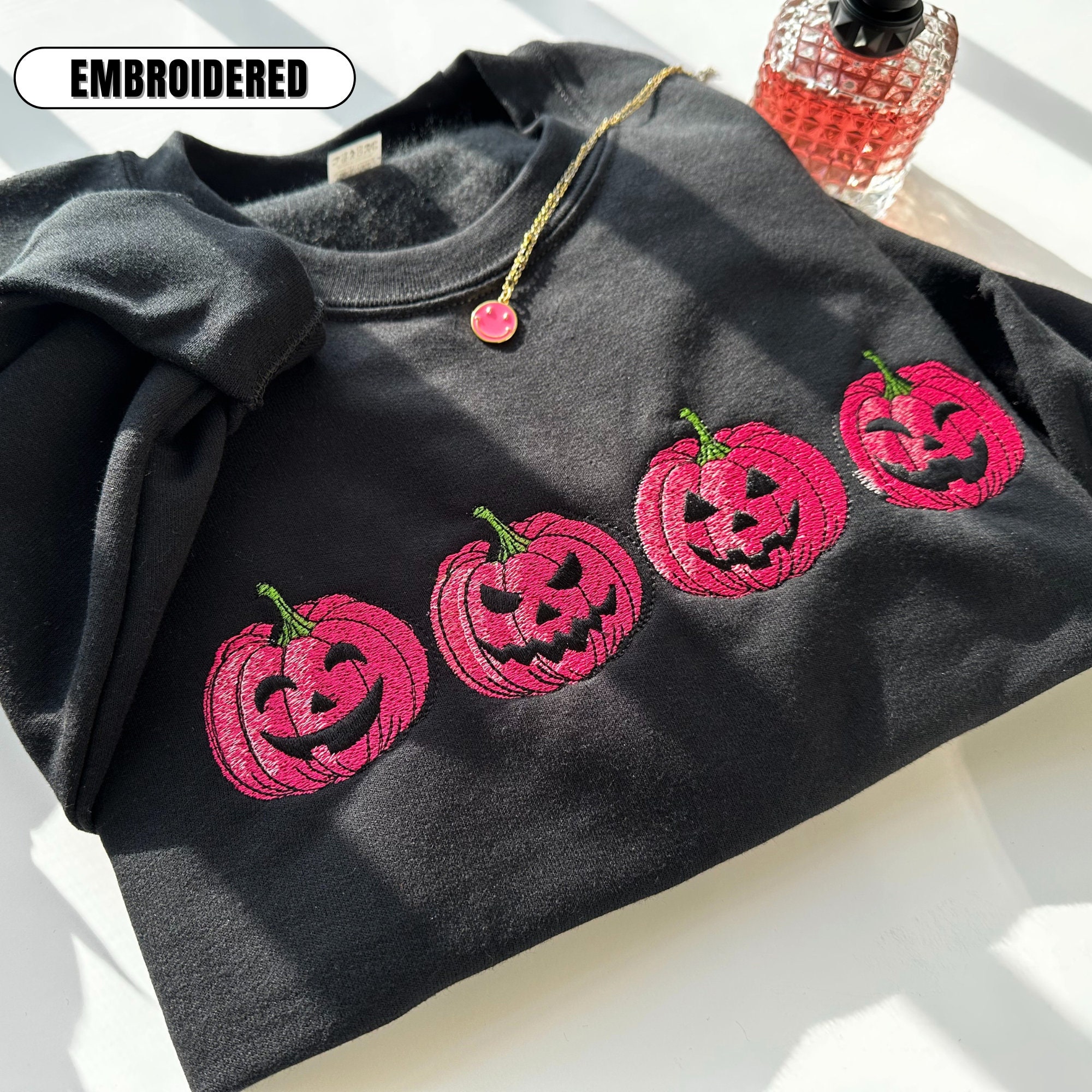 Discover Embroidered Pink Spooky pumpkin Face Crewneck sweatshirt, Halloween Crewneck Sweatshirt, Halloween Sweater, Spooky Season