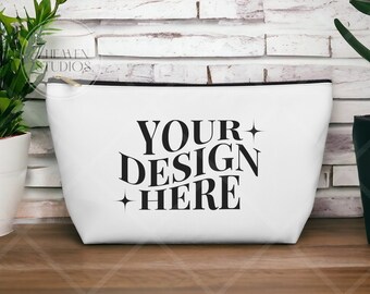 May include: White canvas zippered pouch with a black zipper and black text that reads "YOUR DESIGN HERE" with a small star on either side of the text.