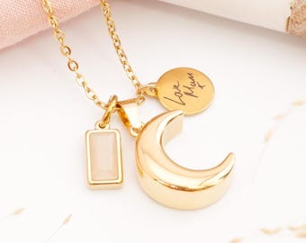 May include: Gold necklace with a crescent moon charm, a small rectangular charm with a light pink stone, and a round charm with the engraved text "Love Mum x".