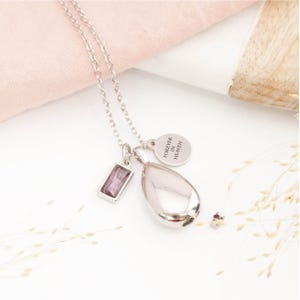 Silver teardrop urn necklace with February birthstone and personalised engraved tag for ashes