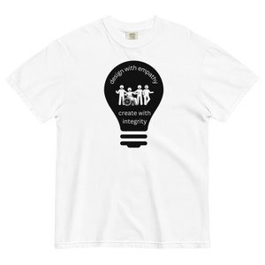 May include: White t-shirt with a black lightbulb graphic. The lightbulb has a group of stick figures inside, including one in a wheelchair. The text "design with empathy create with integrity" is printed around the lightbulb.