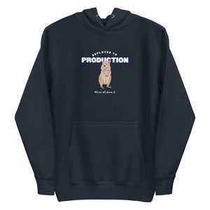 May include: A dark blue hoodie with a kangaroo illustration and the text "DEPLOYED TO PRODUCTION" in a glitched font. The text "We've all done it." is below the image.