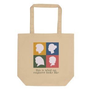 May include: A beige tote bag with a design of four silhouettes of people with different hairstyles. The text "This is what an engineer looks like" is printed below the silhouettes.