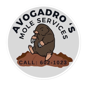 May include: A white circular sticker featuring a cartoon mole in the centre. The mole is brown with a white belly. The text surrounding the mole reads "Avogadro's Mole Services" in black. The text at the bottom of the sticker reads "Call: 602-1023".