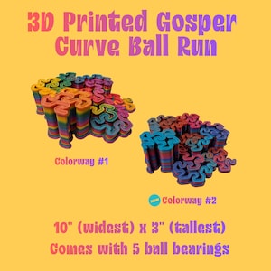 May include: 3D Printed Gosper Curve Ball Run featuring two colourways. Colourway #1 displays a rainbow gradient, while Colourway #2 features blue and purple tones. The structure measures 25.4 cm at its widest and 7.62 cm at its tallest, including 5 ball bearings.