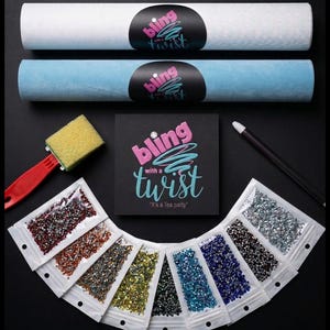May include: An assortment of craft supplies for a tea party theme, including rolls of white and blue fabric, packets of colorful rhinestones, a sponge brush, and a stylus. The "bling with a twist" logo is featured on the packaging.