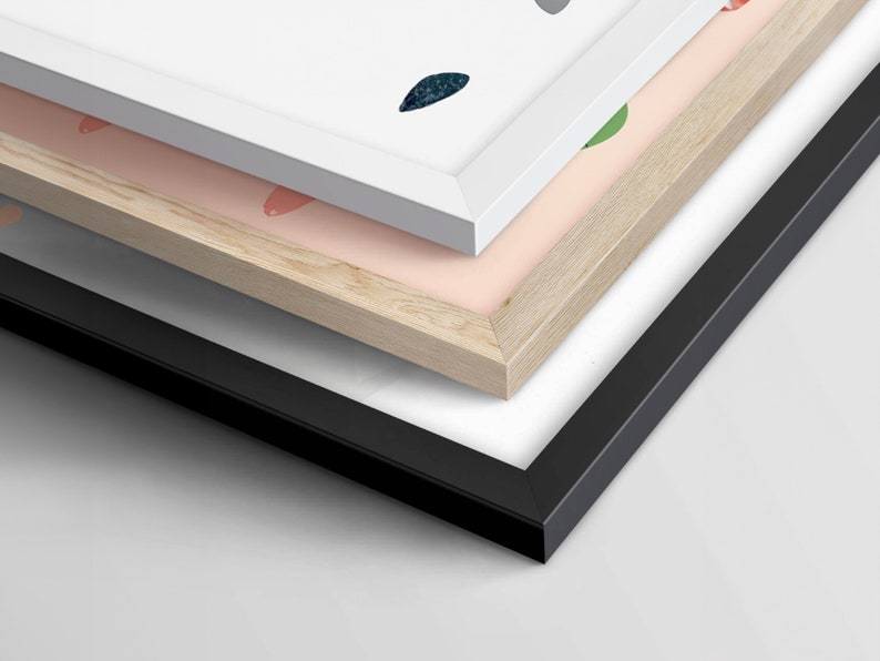 May include: Three picture frames stacked on top of each other. The top frame is white, the middle frame is light wood, and the bottom frame is black.