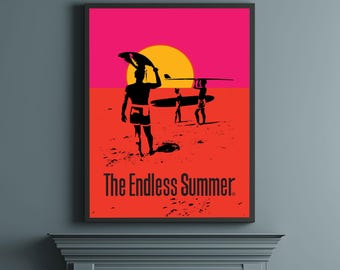 May include: Framed poster featuring a vibrant sunset scene with surfers. Silhouetted figures carry surfboards on a beach under a yellow sun and a pink sky. The text "The Endless Summer" is displayed in red.