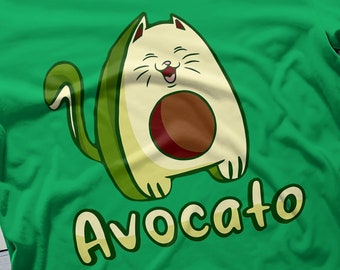May include: Green t-shirt with a cartoon avocado cat wearing a smile and the word "Avocoato" printed on the front.