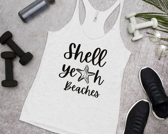 May include: A light grey racerback vest with the words "Shell Yeah Beaches" in black script and a starfish graphic. The vest is surrounded by fitness equipment, including dumbbells and a water bottle.
