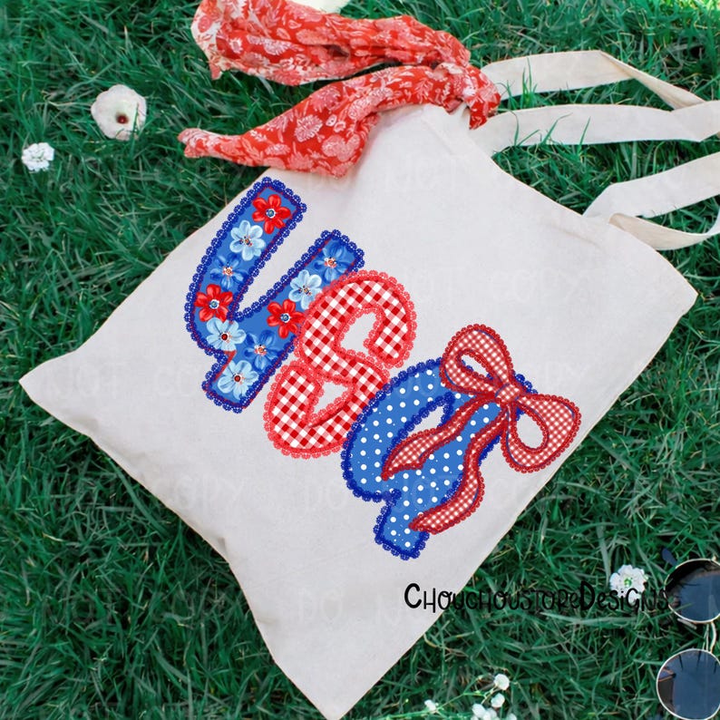 May include: A white tote bag with the word "USA" appliqued in red, white, and blue fabric. The "U" is blue with floral accents, the "S" is red gingham, and the "A" is blue with white polka dots and a red gingham bow.