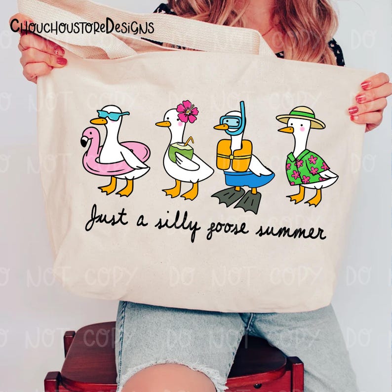 May include: A beige tote bag featuring a whimsical illustration of four cartoon geese in summer attire. One goose wears sunglasses and a flamingo floatie, another holds a coconut drink, and the last wears a Hawaiian shirt. The text "Just a silly goose summer" is below.
