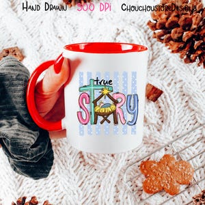May include: A white ceramic mug with a bright red handle and interior. The mug features a colorful graphic with the text "true story" and a nativity scene illustration including a manger, a star, and a cross against a blue polka dot background.