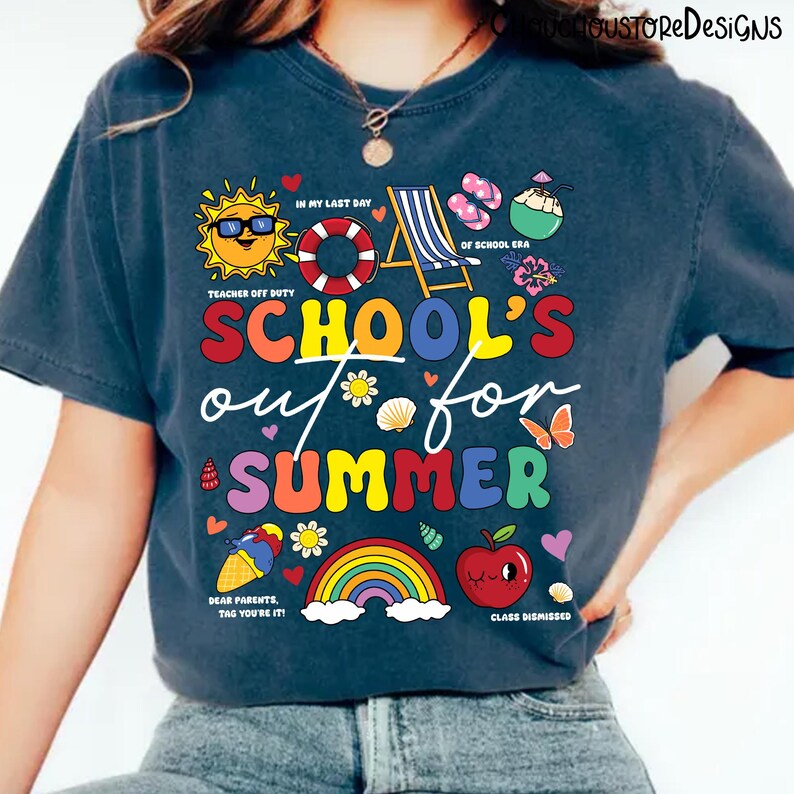 May include: Navy blue t-shirt with a colorful graphic that reads "SCHOOL'S out for SUMMER". The design includes a sun, beach chair, rainbow, apple, and other summer-themed illustrations. Text includes "Teacher Off Duty" and "Class Dismissed".