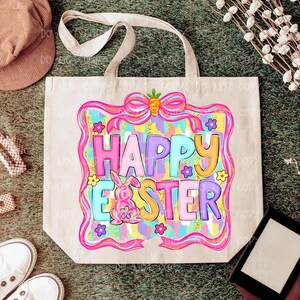 May include: A beige tote bag with a colorful "Happy Easter" design. The design features a pink bow with a carrot, a bunny, flowers, and the words "Happy Easter" in various colors. The bag has two handles.
