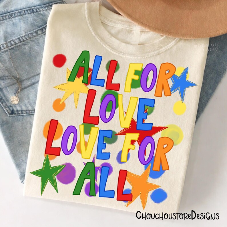 May include: Cream-colored t-shirt with the text "ALL FOR LOVE LOVE FOR ALL" in colorful, block letters. The design includes stars and circles in various colors. The shirt is part of a clothing collection.