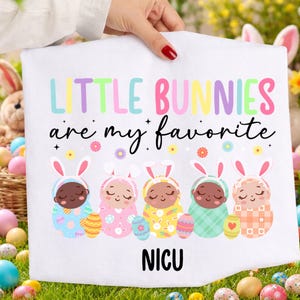May include: White baby blanket with the text "LITTLE BUNNIES are my favorite" in pastel colors. The blanket features five baby bunnies in colorful outfits with Easter eggs. The word "NICU" is at the bottom.