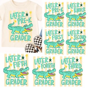 May include: Cream-coloured t-shirt with a teal alligator graphic and the text "LATER PRE-K GRADER." Additional cards feature the same alligator design with grade levels: Kinder, First, Second, Third, Fourth, and Fifth.