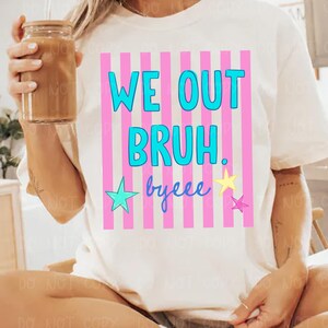 May include: Off-white t-shirt with the text "WE OUT BRUH. byeee" in blue and yellow, set against a pink and white striped background. The shirt features a crew neck and short sleeves.