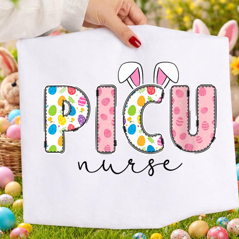 May include: White fabric with the text "PICU nurse" in a colorful Easter egg design. The letters are outlined in black with a stitched effect. Bunny ears are above the "ICU". The background includes Easter eggs and a basket.