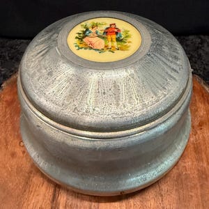 Vintage vanity musical powder puff box with hand-painted Fragonard-style medallion by Cody Musical Creations (Fifth Ave) - brushed aluminum