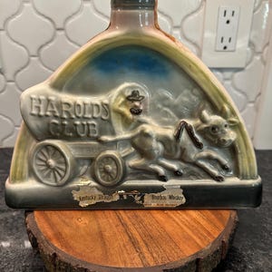 Vintage 1969 Jim Beam decanter shaped like a covered wagon being pulled by oxen, advertising Harold&#39;s Club casino
