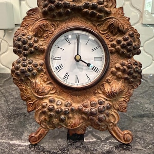 Vintage cast iron mantel clock with grape and leaf clusters - tripod feet - easel back - rococo Victorian style