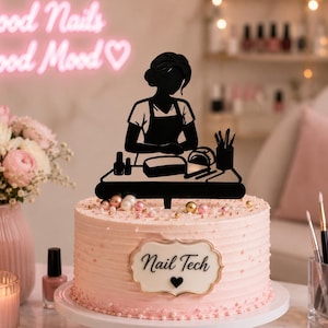 May include: A round, light pink frosted cake topped with a black silhouette cake topper depicting a nail technician at a desk. The cake features a white plaque with the text "Nail Tech" and a small black heart, decorated with edible pearls.