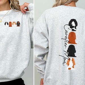 May include: Gray sweatshirt with a row of four Cavalier King Charles Spaniel dog silhouettes on the front and the text "Cavalier Mom" vertically down the back.