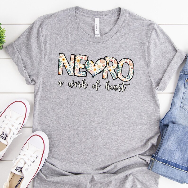 May include: A gray t-shirt with a floral design that says "NEURO a work of heart".