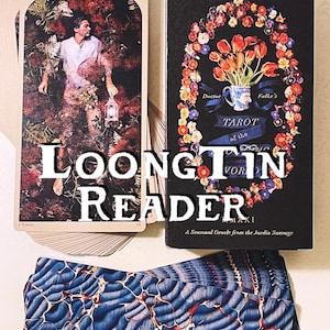 May include: A deck of tarot cards with a floral design on the box. The box is black with gold lettering and the title "Falke's Tarot of the Wild". The cards are arranged in a fan shape with the top card showing a man in a forest.