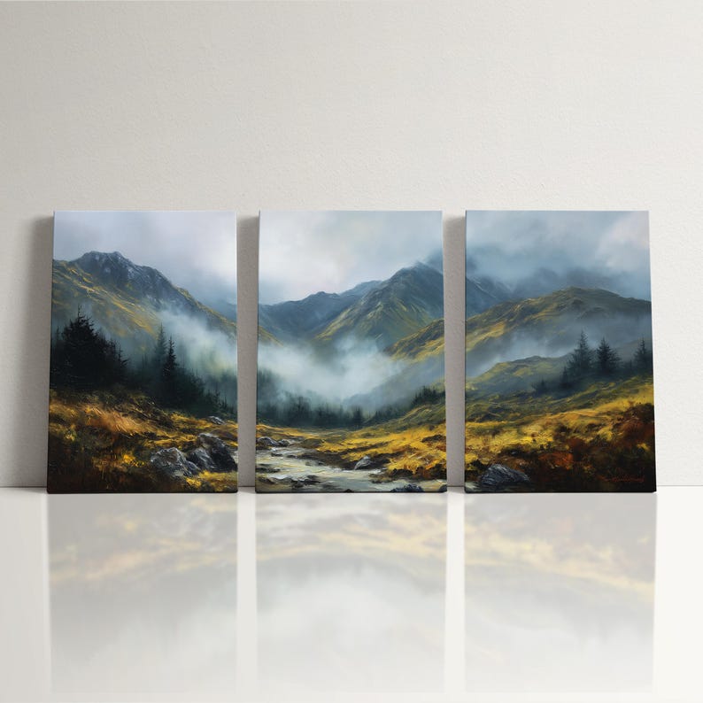 May include: A set of three landscape paintings showing a mountain scene with a river, trees, and mist. The artwork uses greens, yellows, and blues, creating a calm, natural view. The paintings are displayed on a white surface, reflecting the image.