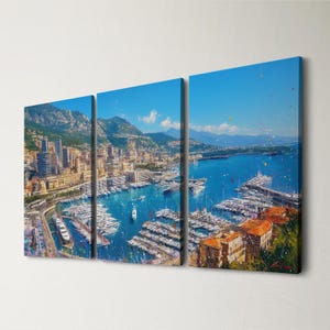 May include: A triptych canvas print depicting a vibrant harbor scene. The artwork showcases a bustling marina filled with boats, surrounded by buildings and mountains under a bright blue sky. The painting uses a textured, impressionistic style.