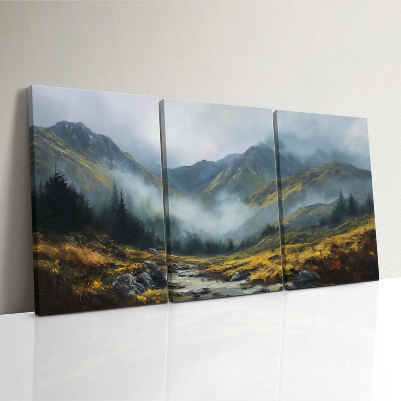 May include: A three-panel canvas print of a mountain scene. The artwork shows a river flowing through a valley, with mountains in the background. The color scheme includes green, yellow, and grey, with a misty atmosphere.