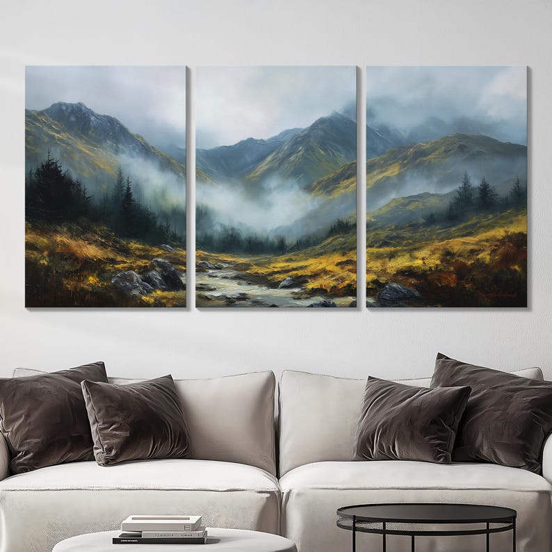 May include: A three-panel canvas print of a mountain landscape with a river. The artwork shows a misty atmosphere, with mountains in the background and golden-yellow fields in the foreground. Dark green trees are scattered throughout the scene.