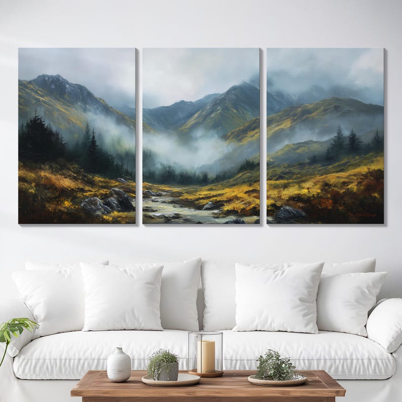 May include: A three-panel canvas print showing a mountain landscape. A river flows through a valley, with mountains in the background. The colour palette includes shades of green, yellow, and grey, creating a tranquil and natural scene.