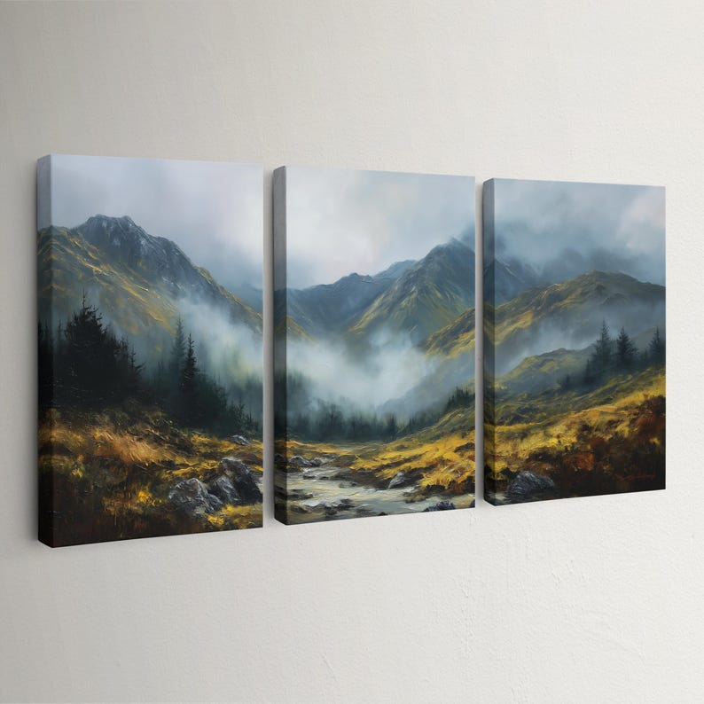 May include: A three-panel canvas print of a mountain landscape. The artwork shows a valley with a river, framed by mountains and trees. The sky is misty, and the colour scheme includes green, yellow, and brown hues.