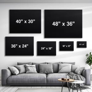 May include: A wall display of six black framed prints with white text indicating the dimensions of each print. The prints are arranged in a staggered pattern, with the largest print at the top and the smallest print at the bottom. The dimensions of the prints are 40" x 30", 48" x 36", 36" x 24", 24" x 18", 18" x 12", and 12" x 8".