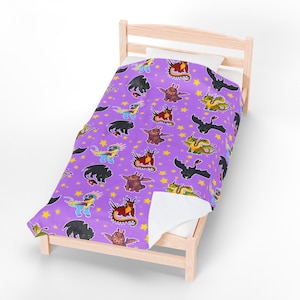 May include: A purple blanket with a repeating pattern of cartoon dragons and yellow stars. The dragons are in various colors, including black, red, green, and blue. The blanket is on a light wood bed frame.