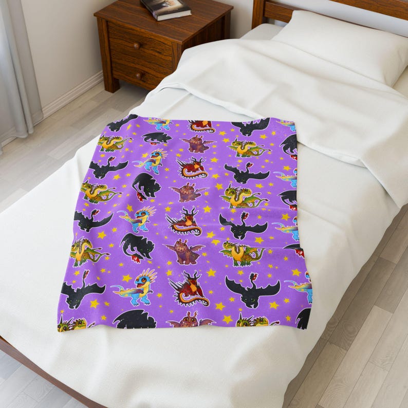 May include: A purple blanket featuring a repeating pattern of colorful cartoon dragons and yellow stars. The dragons are in various poses and colors, creating a whimsical and playful design. The blanket is displayed on a white bed.