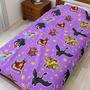 May include: A purple bedspread featuring a repeating pattern of cartoon dragons in various colors, including black, red, green, and blue. Yellow stars are scattered across the background. The bedspread is on a wooden bed frame.
